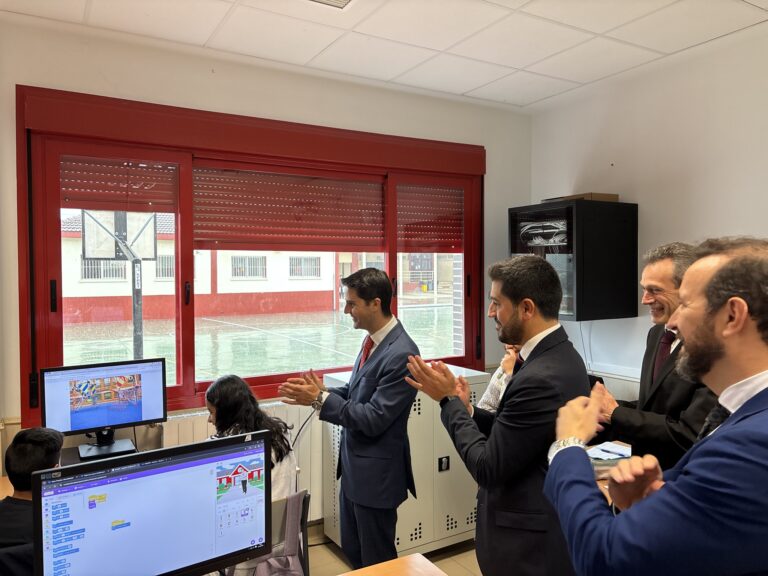 El Consejero de Educación, Viceconsejero y representantes de El Boalo, Cerceda y Mataelpino aplaudiendo a estudiantes en un aula de informática, celebrando el talento y la labor educativa en el IES "El Boalo".